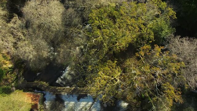 Drone footage of a wooden bridge over Zas River near Castriz village in Santa Comba, A Coruna, Spain