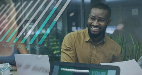 Image of financial data processing over biracial businessman using laptop