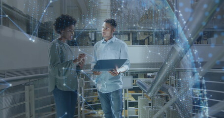 Image of globe and data processing over diverse business people in office