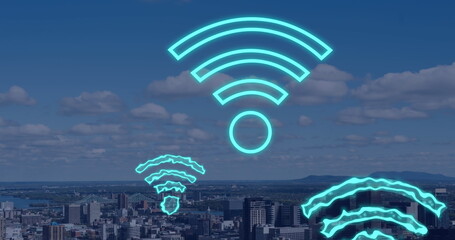 Image of digital wifi icons flying over cityscape