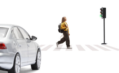 Female teenage student with a backpack walking over a pedestrian crossing and car waiting at...