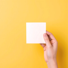 Colorful Sticky Note Held Firmly by a Hand, Close-Up View