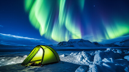 Winter camper in a tent under the northern lights