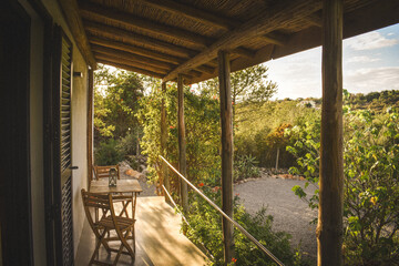 Charming outdoor veranda with stylish furniture set amidst lush trees and shrubs in Portugal
