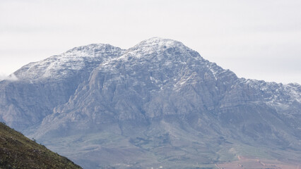 Snow-capped peaks of Breede Valley's distant mountains on a chilly day in Worcester, South Africa