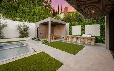 Outdoor dining area with a pool surrounded by lush greenery
