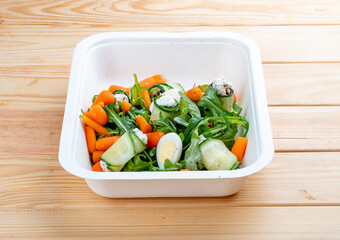Cucumber rolls with sun-dried tomatoes. Healthy food. Takeaway food.  On a wooden background.
