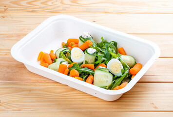 Cucumber rolls with sun-dried tomatoes. Healthy food. Takeaway food.  On a wooden background.