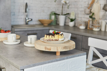 Modern kitchen breakfast setting with artificial cheesecake and fresh berries