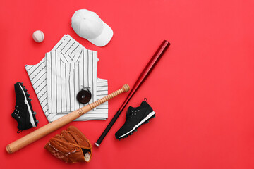 Flat lay composition with baseball uniform and sports equipment on red background. Space for text