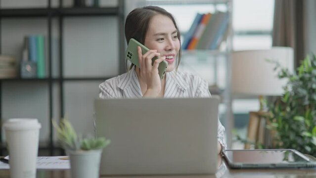 Young Asian businesswoman work at home and virtual video conference meeting with colleagues business people,online working,remote work,video call,remote working discuss concersation strategy business
