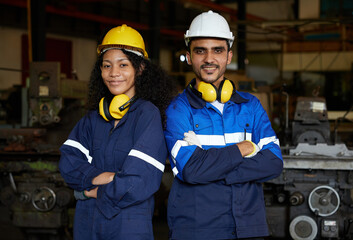 workers or engineers smiling and crossed arms pose in the factory