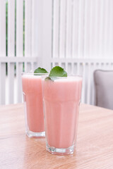 Strawberry milkshake on a table in the cafe.