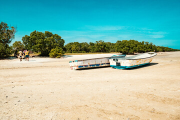 Fototapeta na wymiar Tourists walking on the beach at Mida Creek during low tide in Watamu, Malindi, Kenya