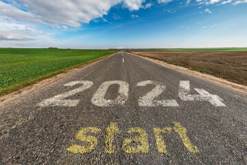 numbers 2023, 2024 and start on asphalt road highway with sunrise or sunset sky background. ...