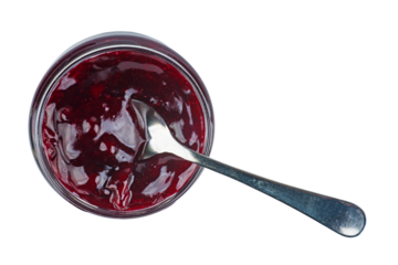 Mixed berry jam in glass jare with spoon isolated on a white background.Top view