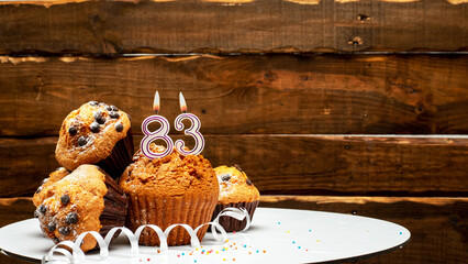 Pies with a number 83  of candles burning for the anniversary. Copy space background happy birthday...