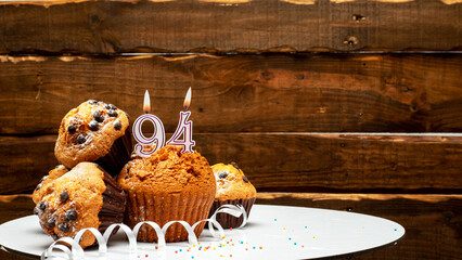 Pies with a number 94  of candles burning for the anniversary. Copy space background happy birthday...