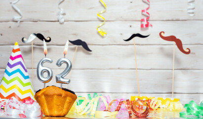 Birthday with number  62. Date of birth with number and candles, copy space. Anniversary background...