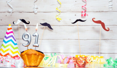 Birthday with number  91. Date of birth with number and candles, copy space. Anniversary background with cake or muffin with burning candles. Keative postcard congratulations. - obrazy, fototapety, plakaty