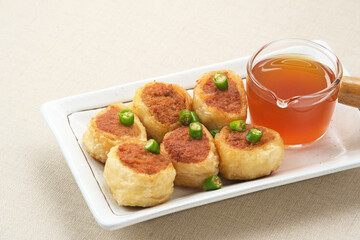 Gohyong or Ngo Hiang, made from minced chicken with flour, served with sour sauce
