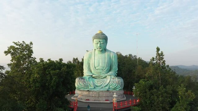 Aerial view of The Great Buddha at Doi Phra Chan is a towering bronze Buddha statue that can be reached by climbing 628 steps up at wat Prathat Doi Prachan, Pa Tan, Mae Tha District, Lampang, Thailand
