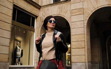 Attractive Woman In Sunglasses Walks In City With Backpack, Female Tourist Looking Around