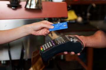 Asian female customer hand holding credit card order swipe pay products cafe business owners men many nationalities holding credit card swipe machines coffee shops restaurants, bakeries small business