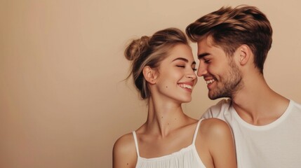 A young couple sharing a tender moment against a soft neutral background.