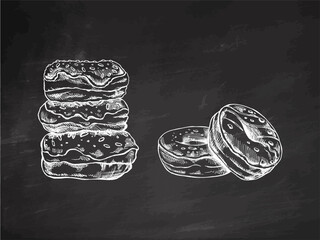 A set of hand-drawn sketches of donuts isolated on chalkboard background. Vintage illustration. Pastry sweets, dessert. Element for the design of labels, packaging and postcards.