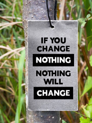 Inspirational Quote Concept - if you change nothing, nothing will change text on paper with nature background. Stock photo.