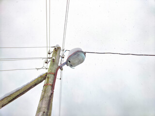 Old pole with wires against the sky. Electric transmission line. Eco-friendly energy