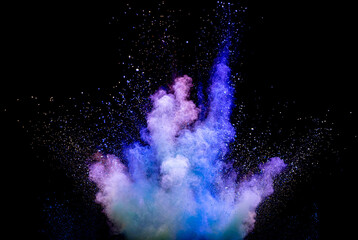 Explosion of multicolored blue purple powder on a black background