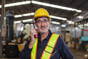 engineer use walkie talkie at machine factory
