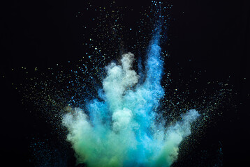 Explosion of blue powder, dusty smoke on black background