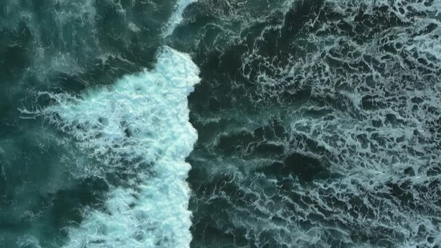 Drone flight over the dark waves of the ocean.