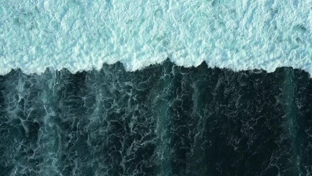 Drone flight over the dark waves of the ocean.