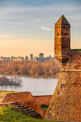 golden hues of sunset atop Belgrade's Kalemegdan fortress, where visitors are greeted by historic battlements and panoramic views of the Danube.