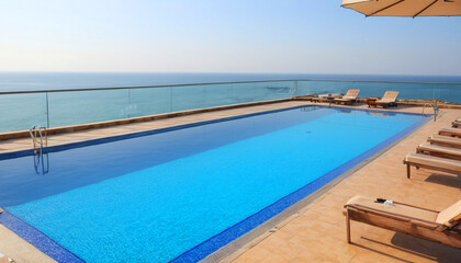 Clean swimming pool outside hotel against beautiful sea view 4