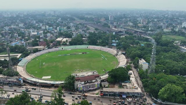 Aerial perspective of Rajshahi city in Bangladesh, nestled by the serene banks of the Padma River. Marvel at its vibrant urban landscape, rich heritage in this captivating drone footage. 4k