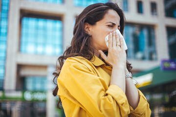 Woman Blowing Her Nose With Handkerchief In Public Parkf. Sick Young Woman With Seasonal Influenza...
