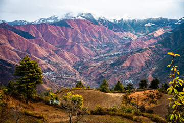 Snow capped mountain peaks and deep valleys with mountain ridges in the Himalayas. Yamnotri region,...