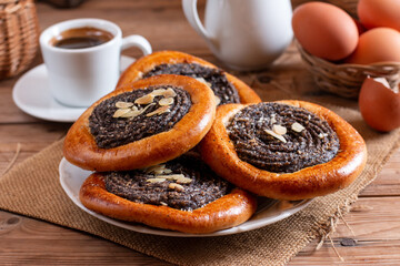 Poppy seed rolls and cardamom buns, Traditional Nordic baked sweet breads on board. Homemade bakery concept for background and wallpaper.