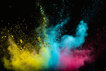 Explosion of colored multi-colored powder on a black background