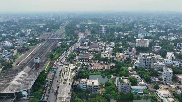 Aerial perspective of Rajshahi city in Bangladesh, nestled by the serene banks of the Padma River. Marvel at its vibrant urban landscape, rich heritage in this captivating drone footage. 4k
