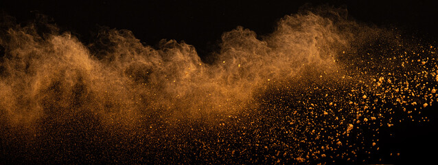 Orange powder dust smoke on black background