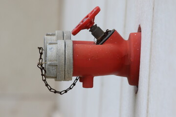 red fire hydrant mounted on the wall