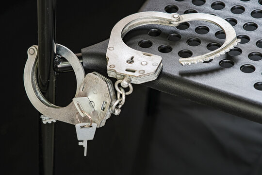 Handcuffs are chained to a chair and prepared for the interrogation of the criminal.