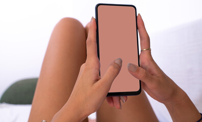 Use green screen for copy space closeup. Chroma key mock-up on smartphone in hand. Woman holds...