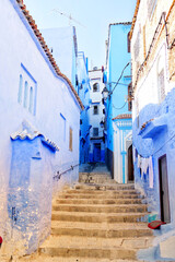 Fototapeta na wymiar Traditional houses along alleyway in Chefchaouen, Morocco